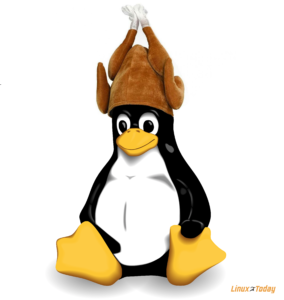Tux, wearing a turkey hat for Thanksgiving.